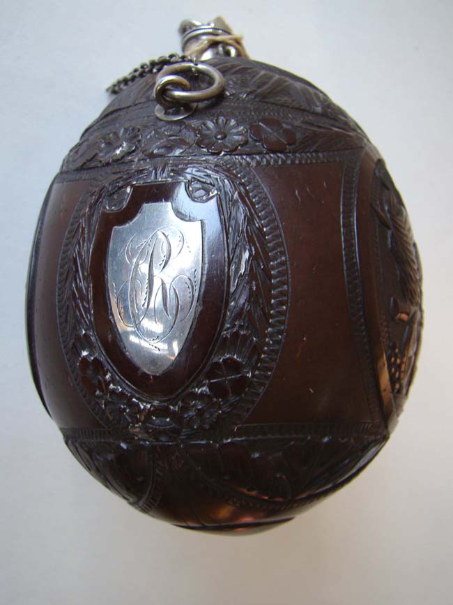 A superbly carved and silver mounted late 18th century Coconut shell gunpowder flask circa 1790
